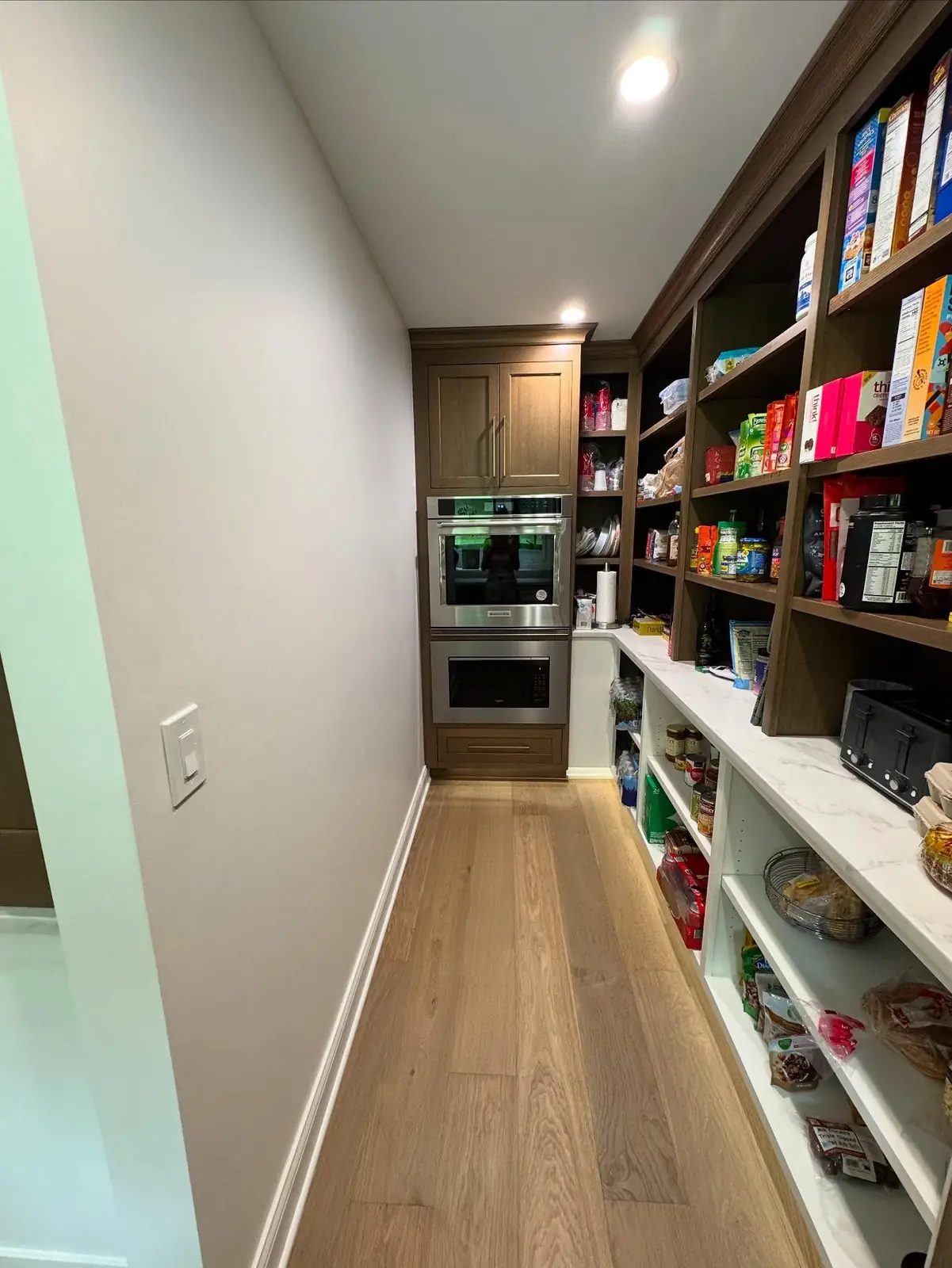 Walk-in pantry with floor-to-ceiling open shelving