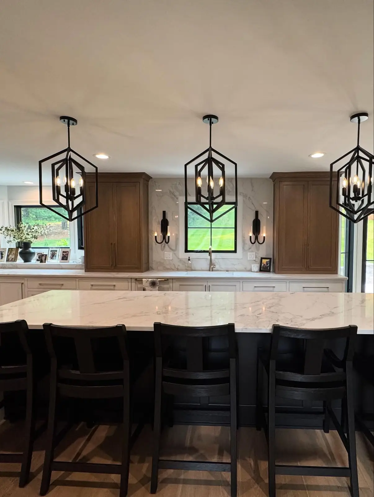 Kitchen after — island seating beneath lantern pendants