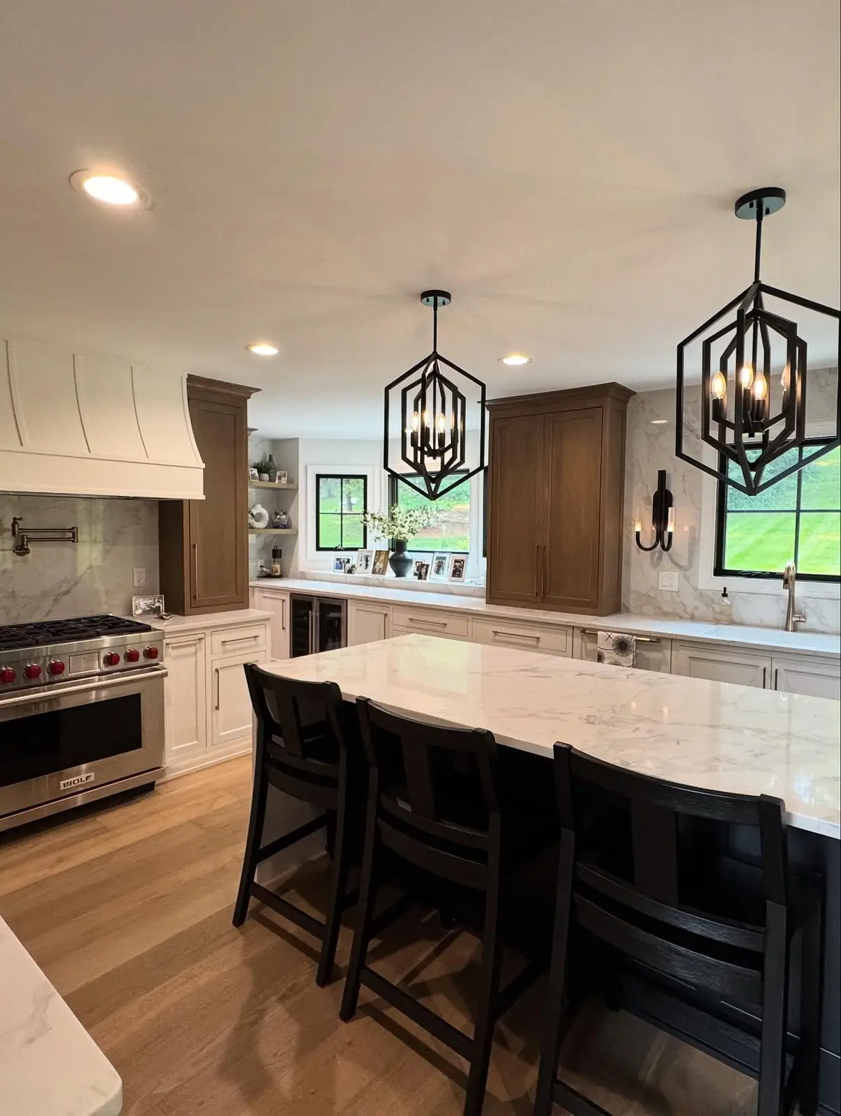 Kitchen with dark wood cabinetry and white island