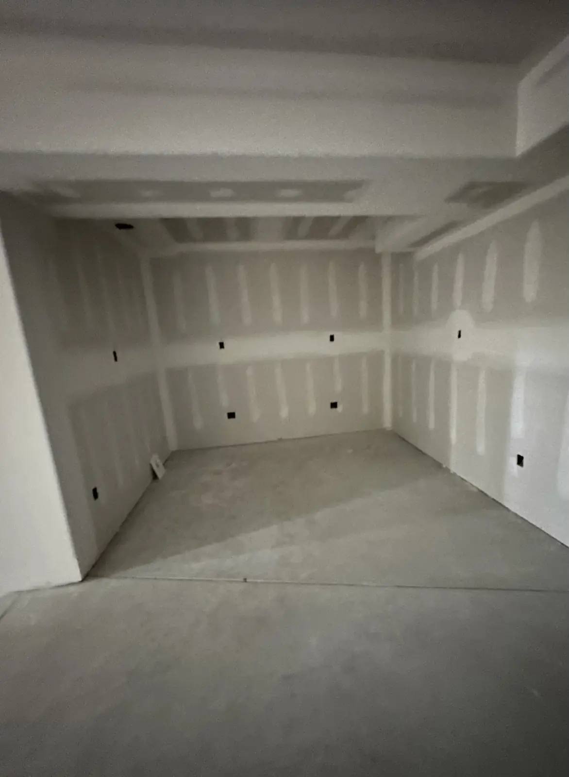 Gaming room before — bare drywall