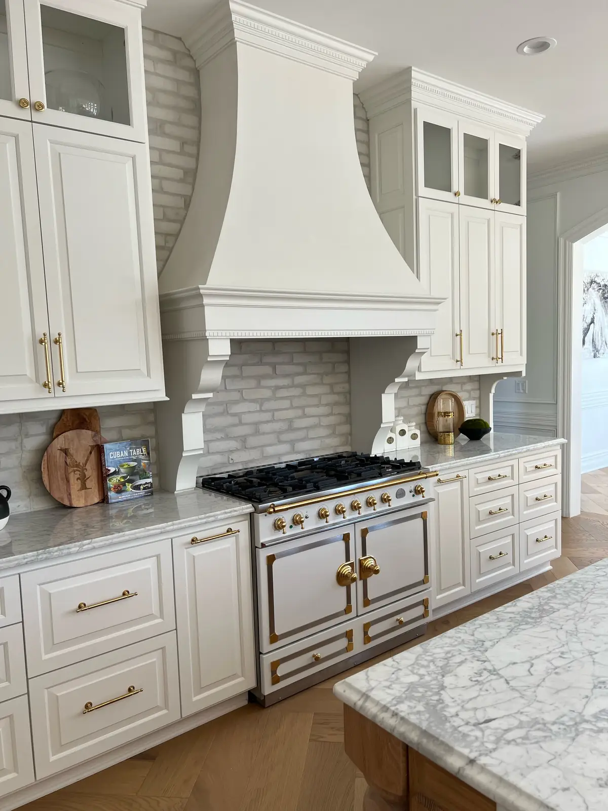 Plaster hood over a brick backsplash — French-Inspired Residence