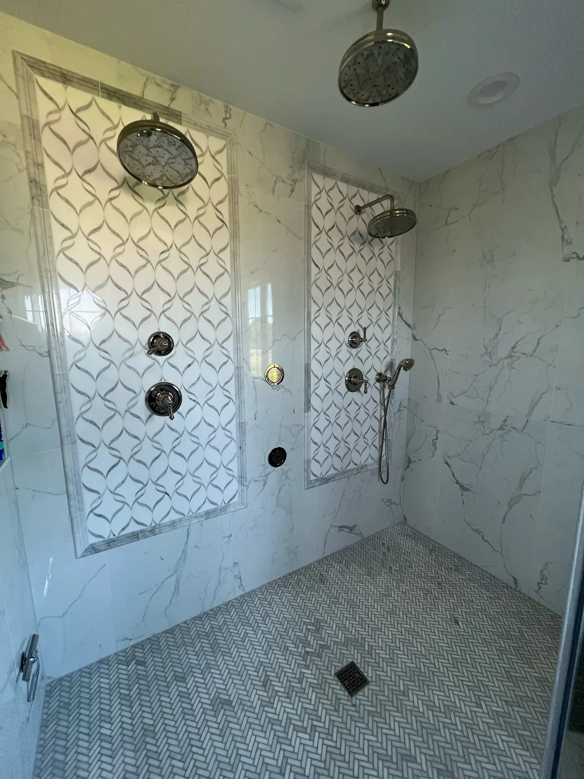Marble shower with mosaic panels — French-Inspired Residence