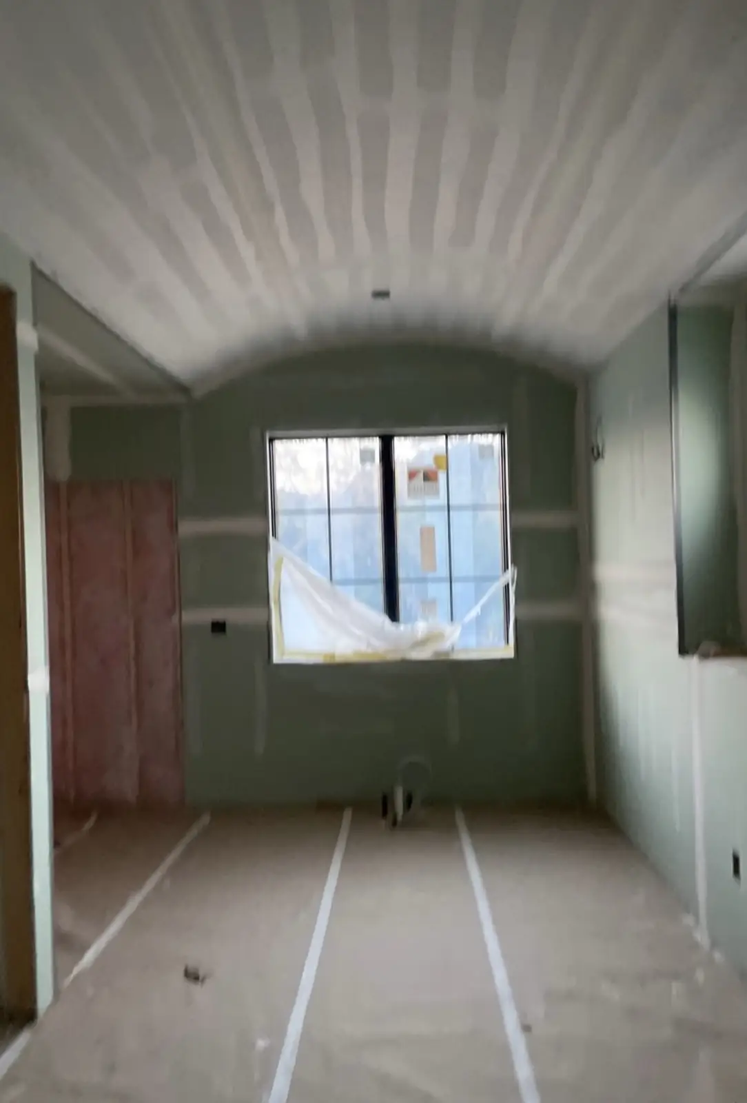Primary bath before — the barrel vault at the drywall stage