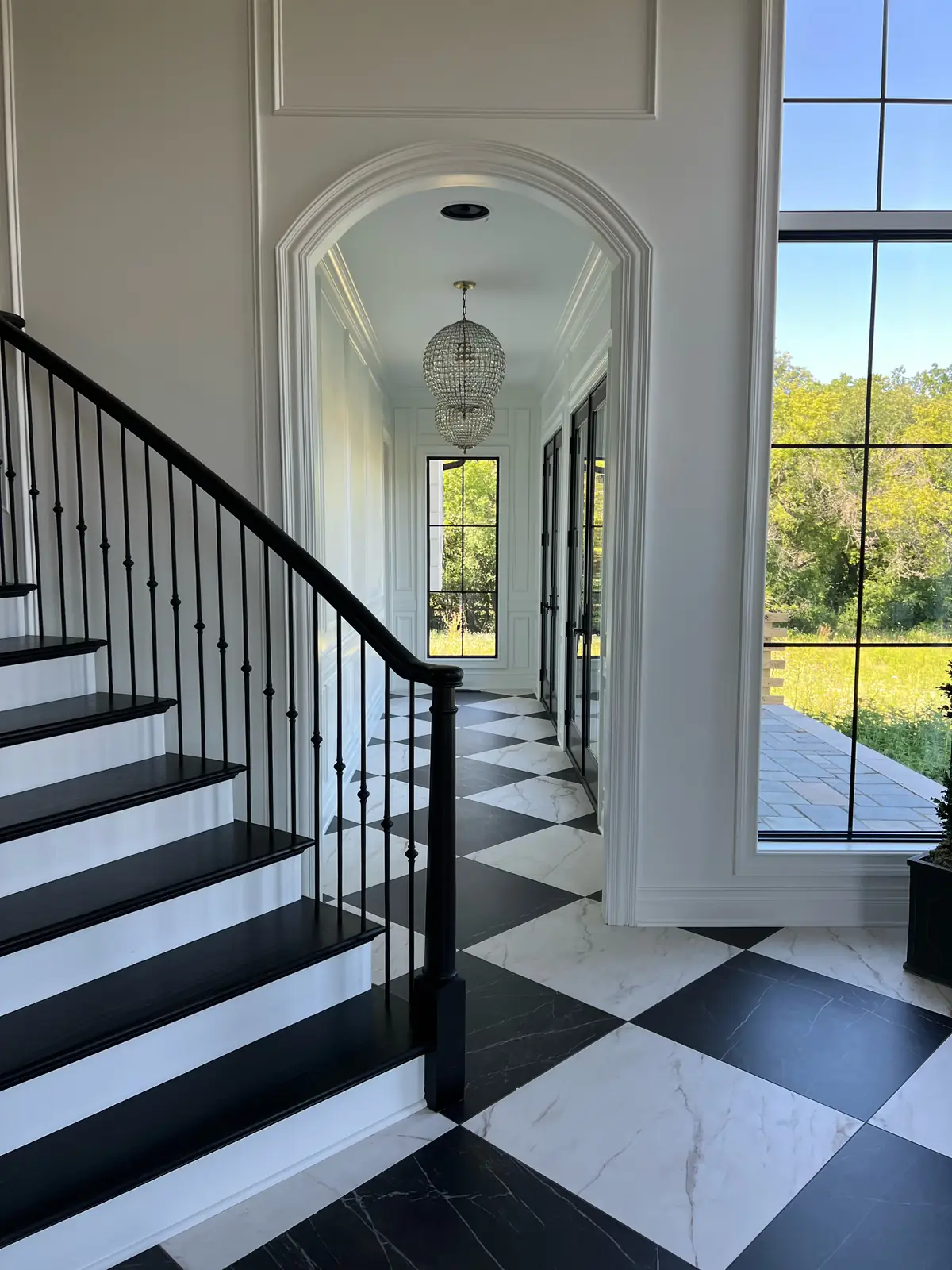 The foot of the stair with the arched hall beyond