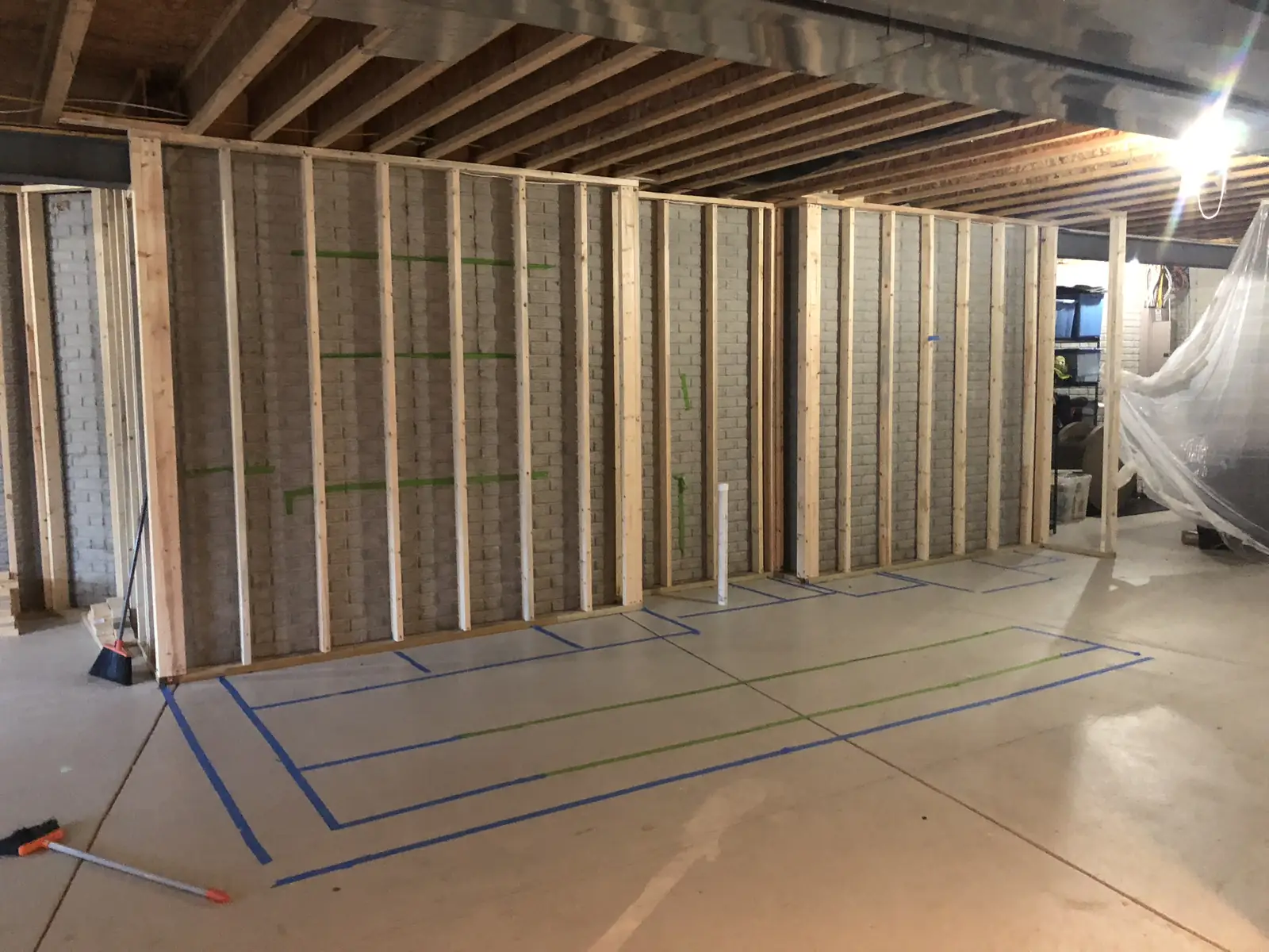 Bar before — framing, with the bar layout taped on the floor