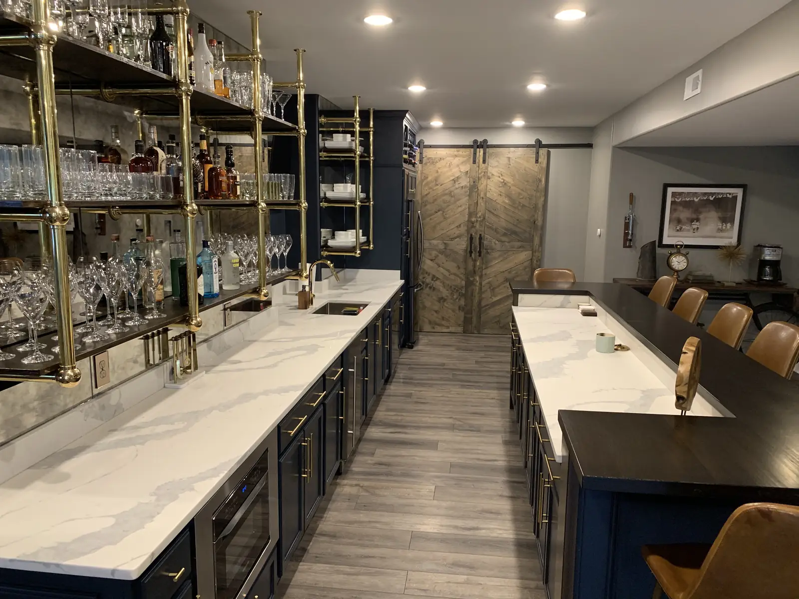 Looking down the bar run beneath brass shelving