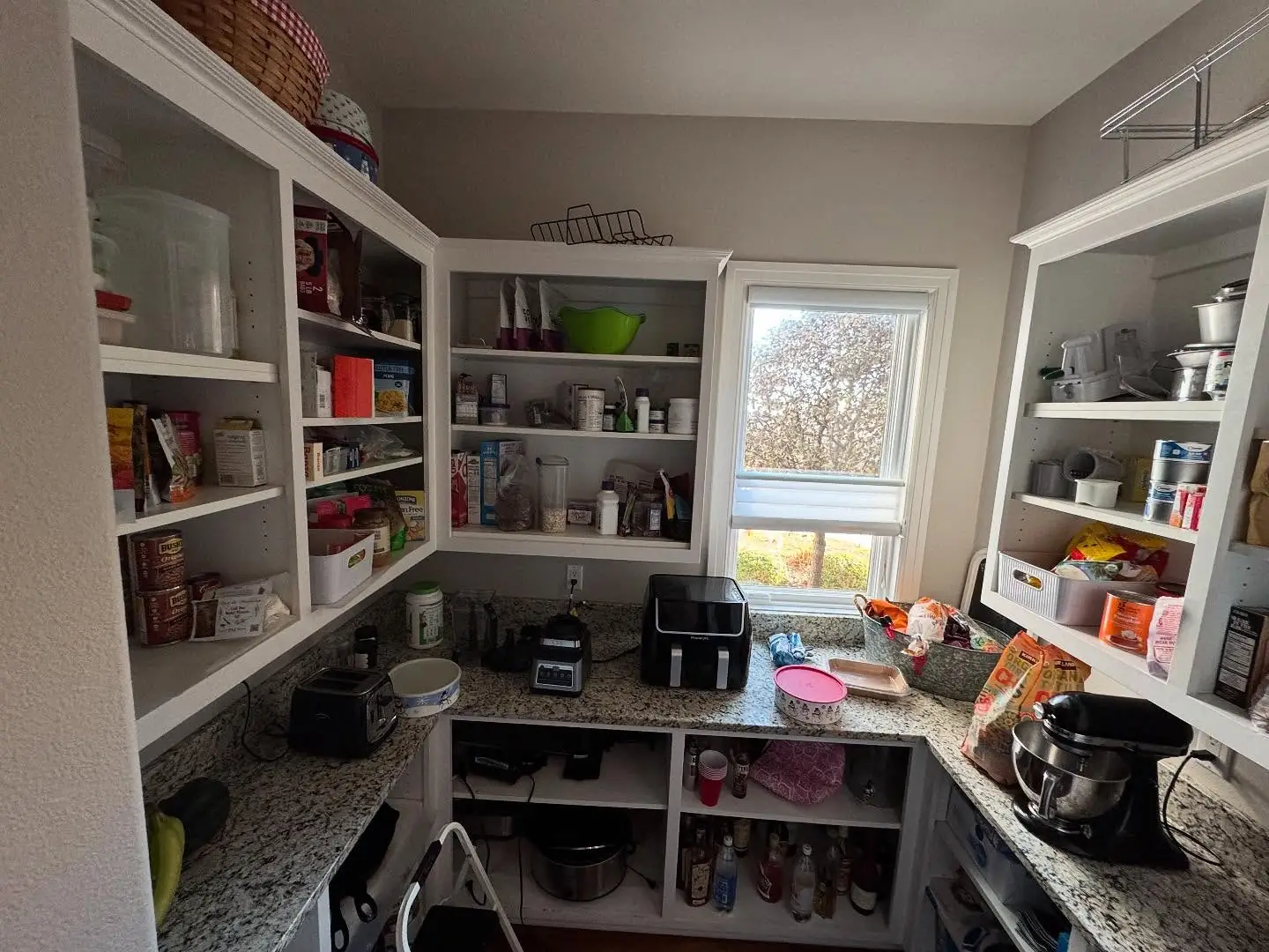 Pantry before — white corner shelving