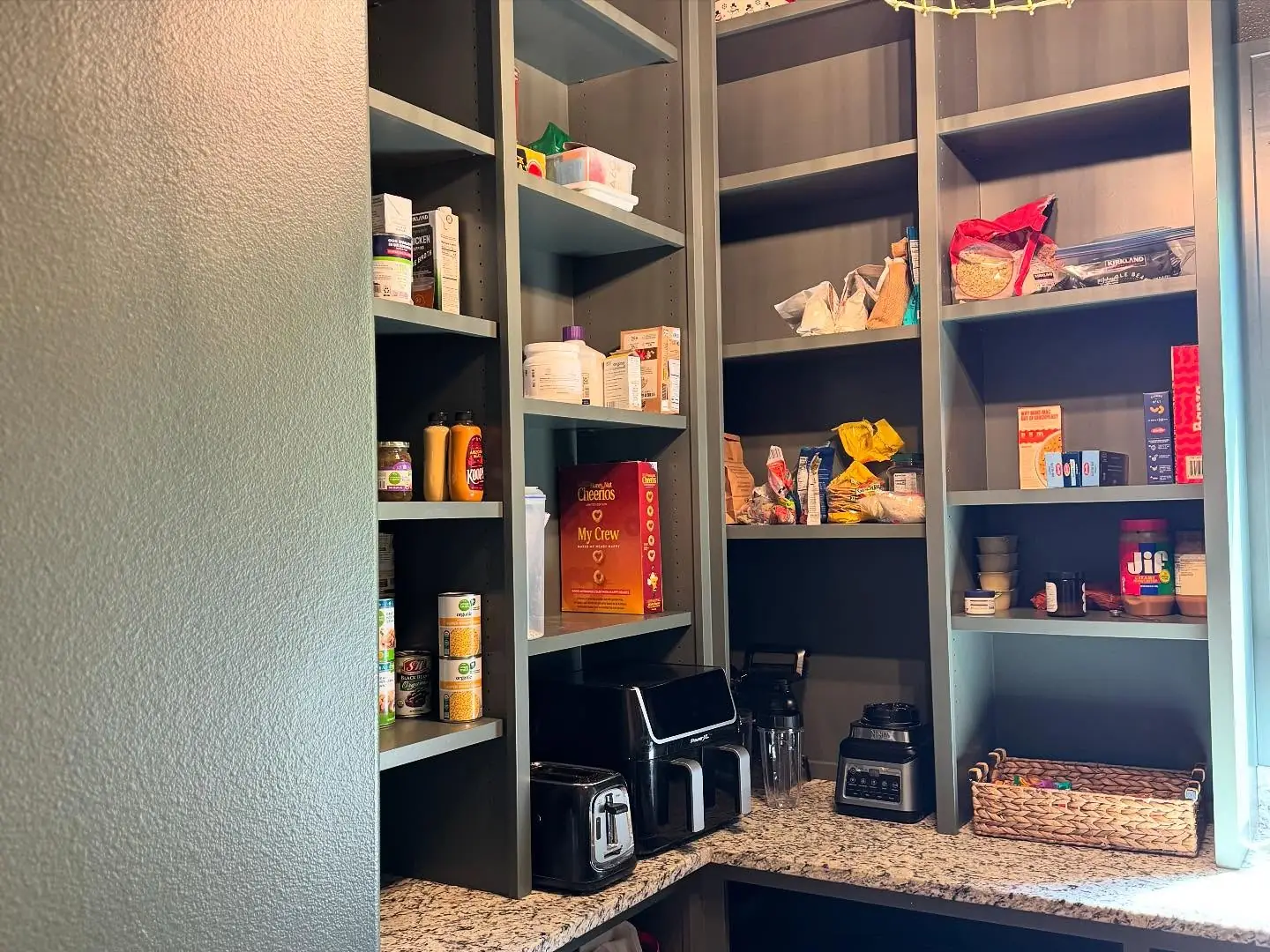 Pantry after — dark corner shelving and counter