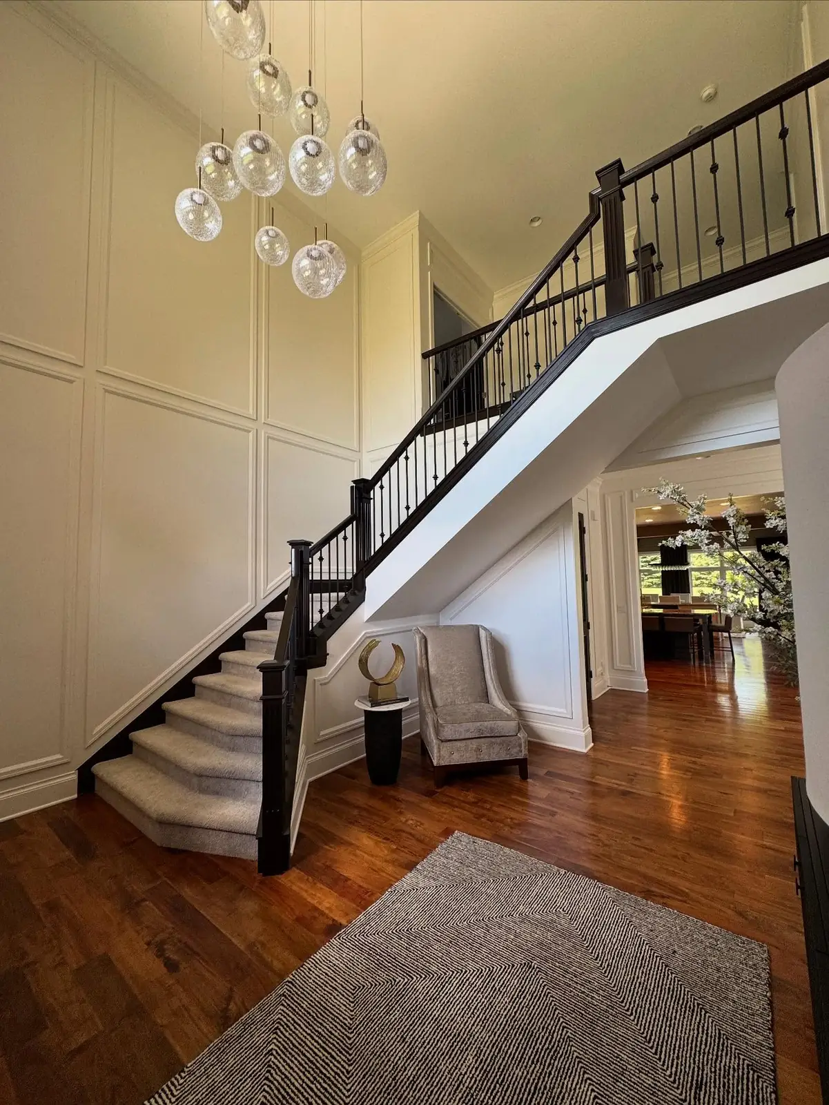 Staircase after — a crystal chandelier and a calmer palette
