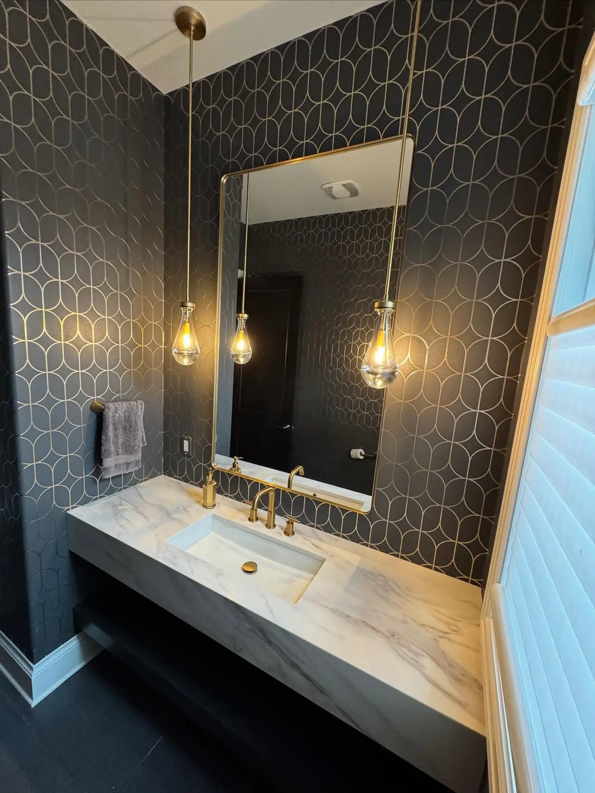 Floating stone vanity and gold pendants