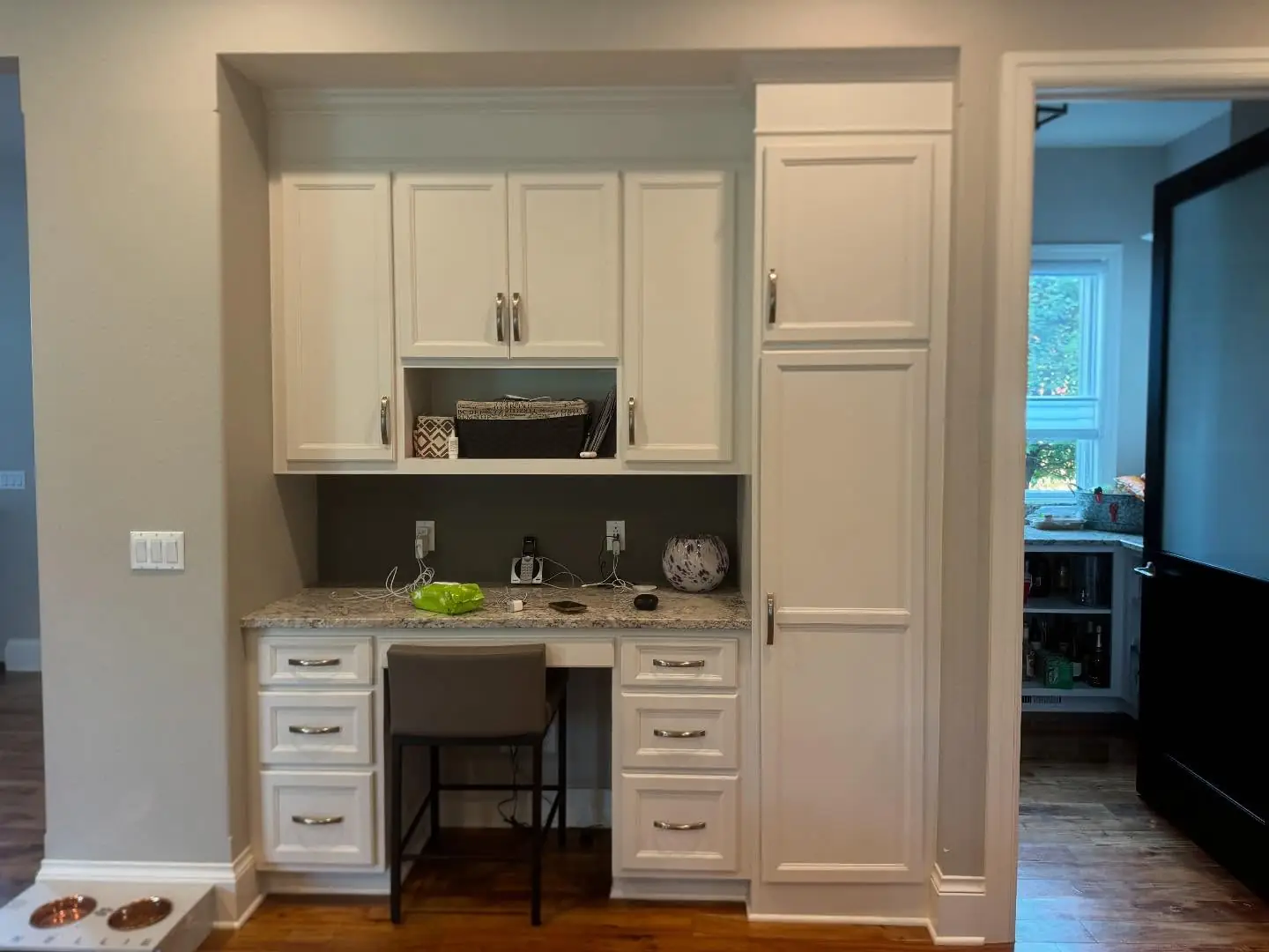 Desk nook before — white cabinetry and a built-in desk