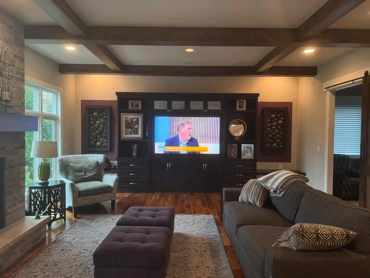 Living room before — dark built-ins around the TV