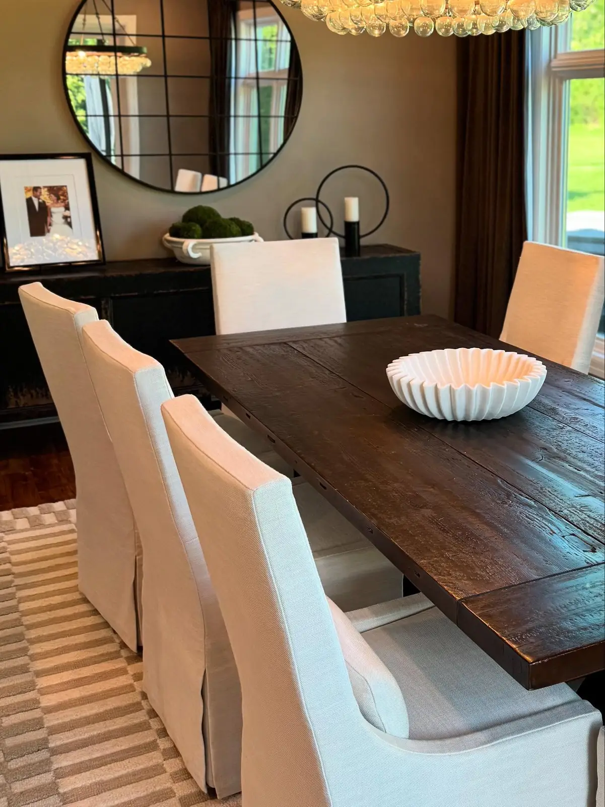 Dining table with white slipcovered chairs
