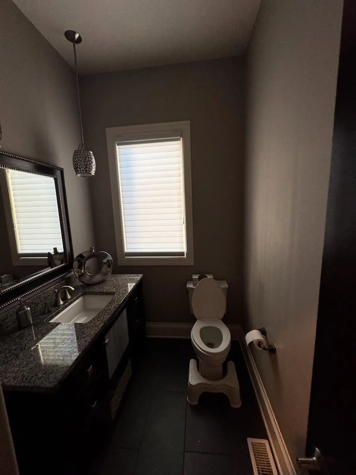 Powder room during — walls painted dark