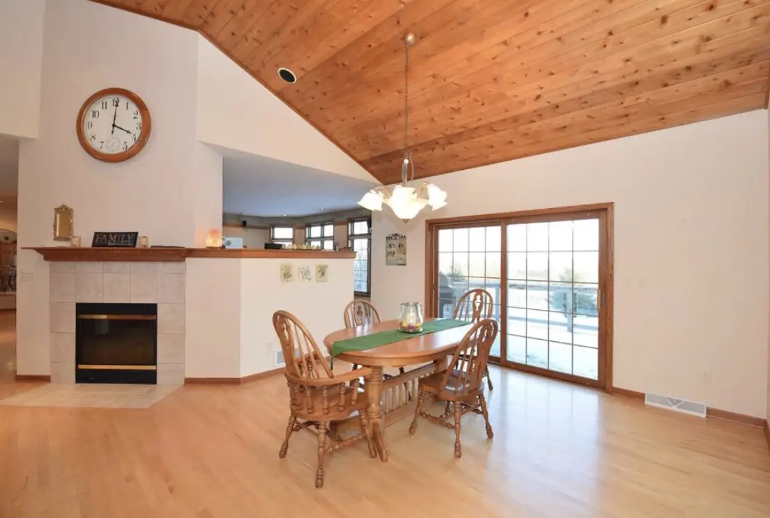Dining area before — a tile fireplace and oak table