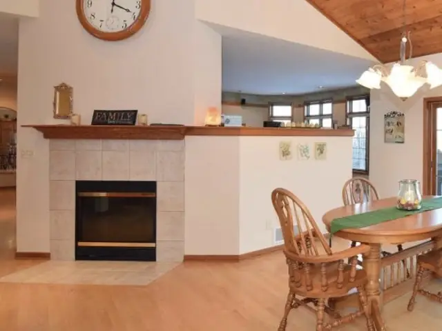 Fireplace before — a tile surround with an oak mantel