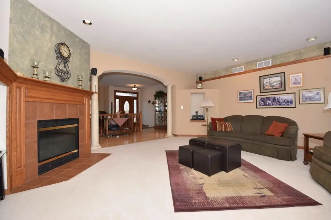 Living room before — a peach wall, green sofa and carpet
