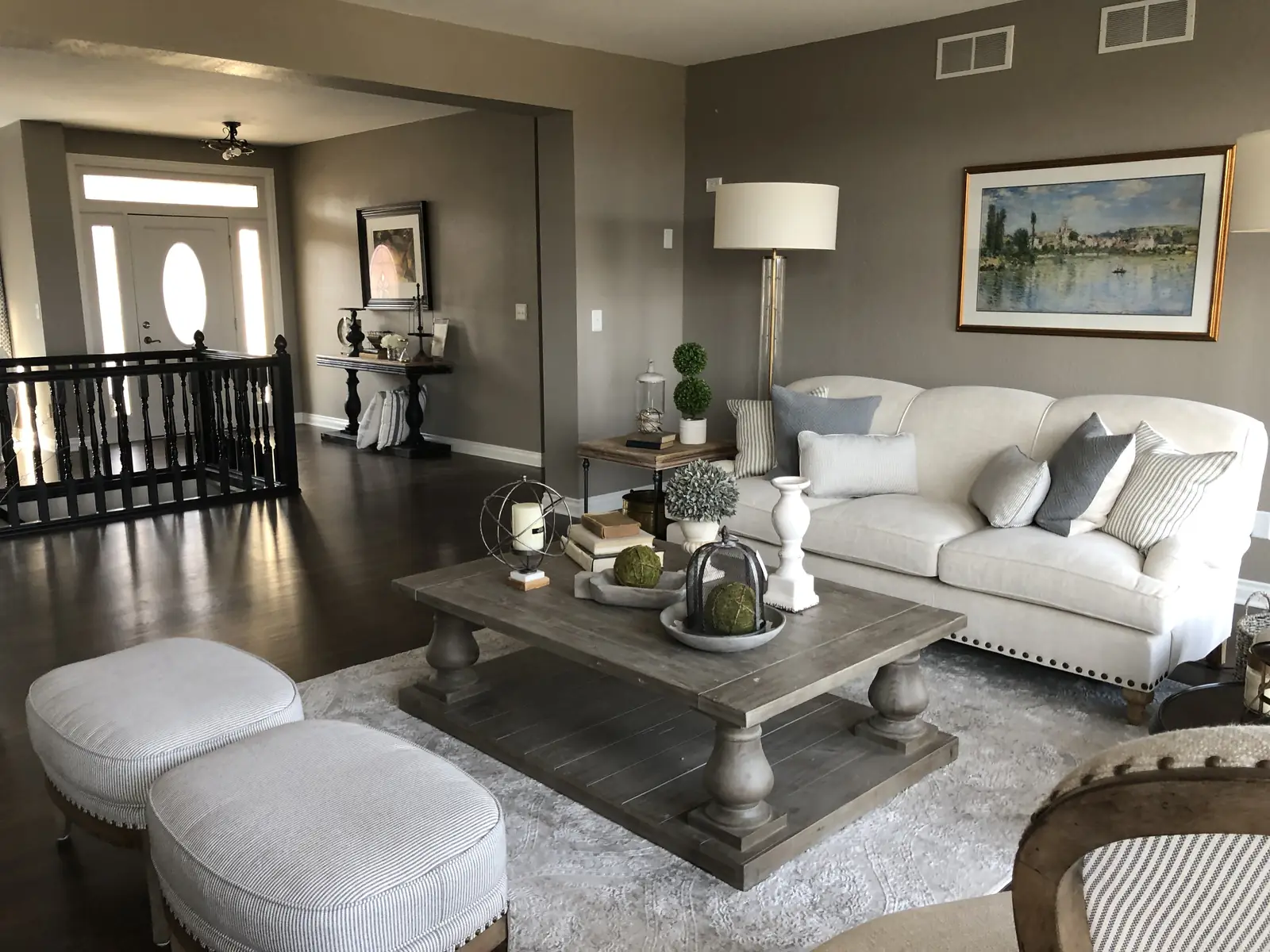 Ridgefield living room with a tufted sofa and paired ottomans