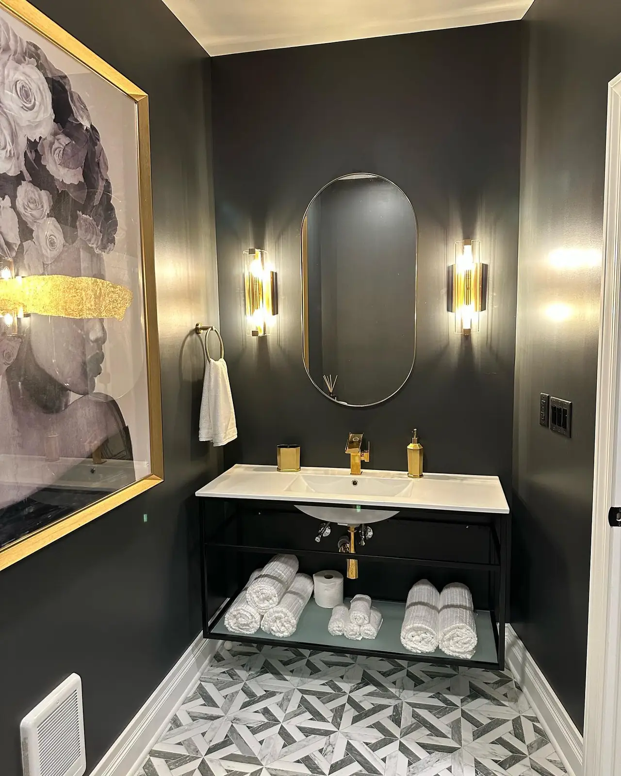 Gold sconces and an oval mirror
